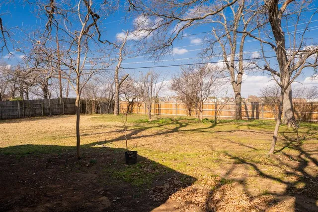 a view of yard with wooden fence