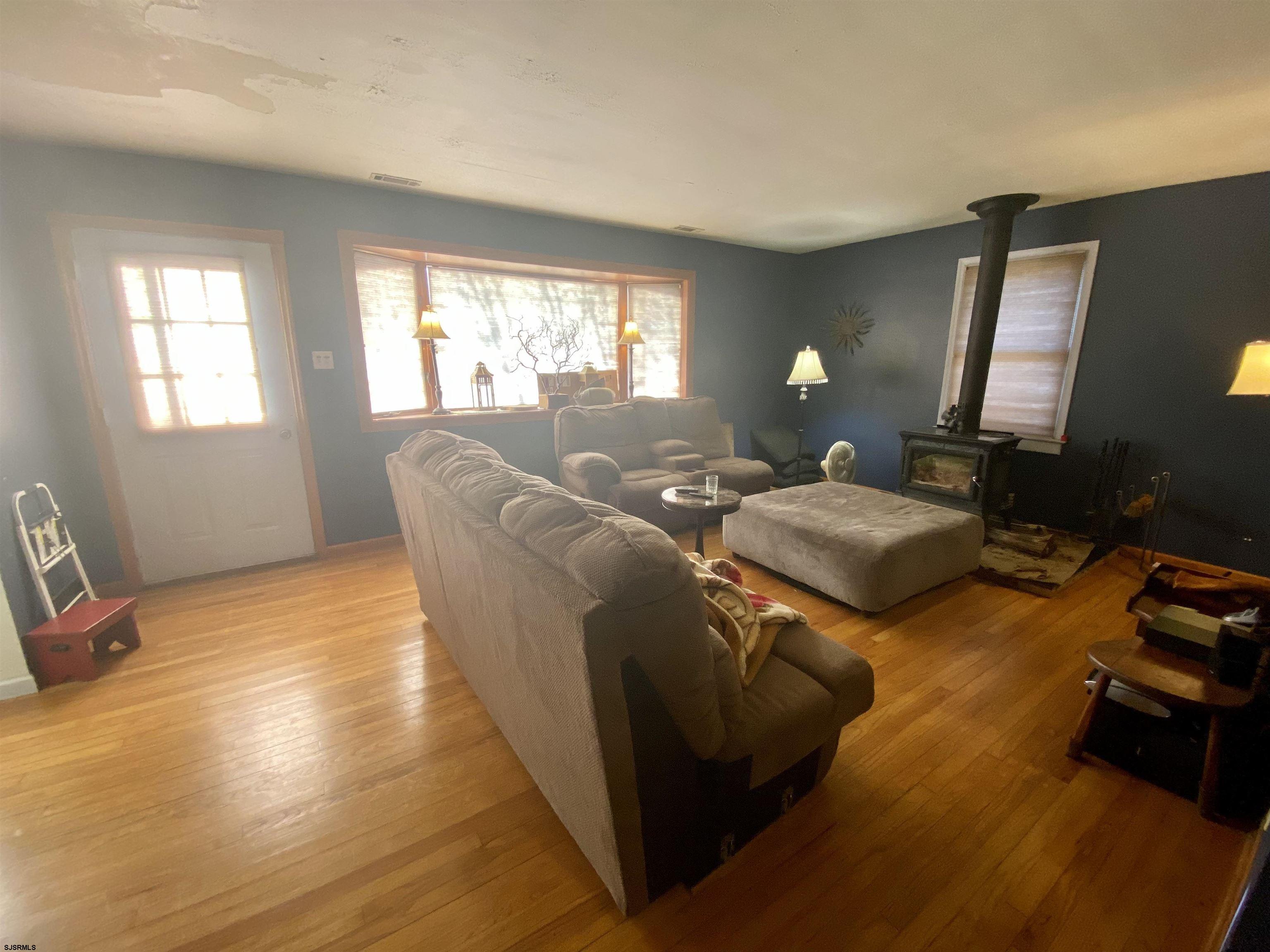 6705 Weymouth Road Mays Landing, NJ 08330 - Photo 21 of 38 a living room with furniture a lamp wooden floor and a large window