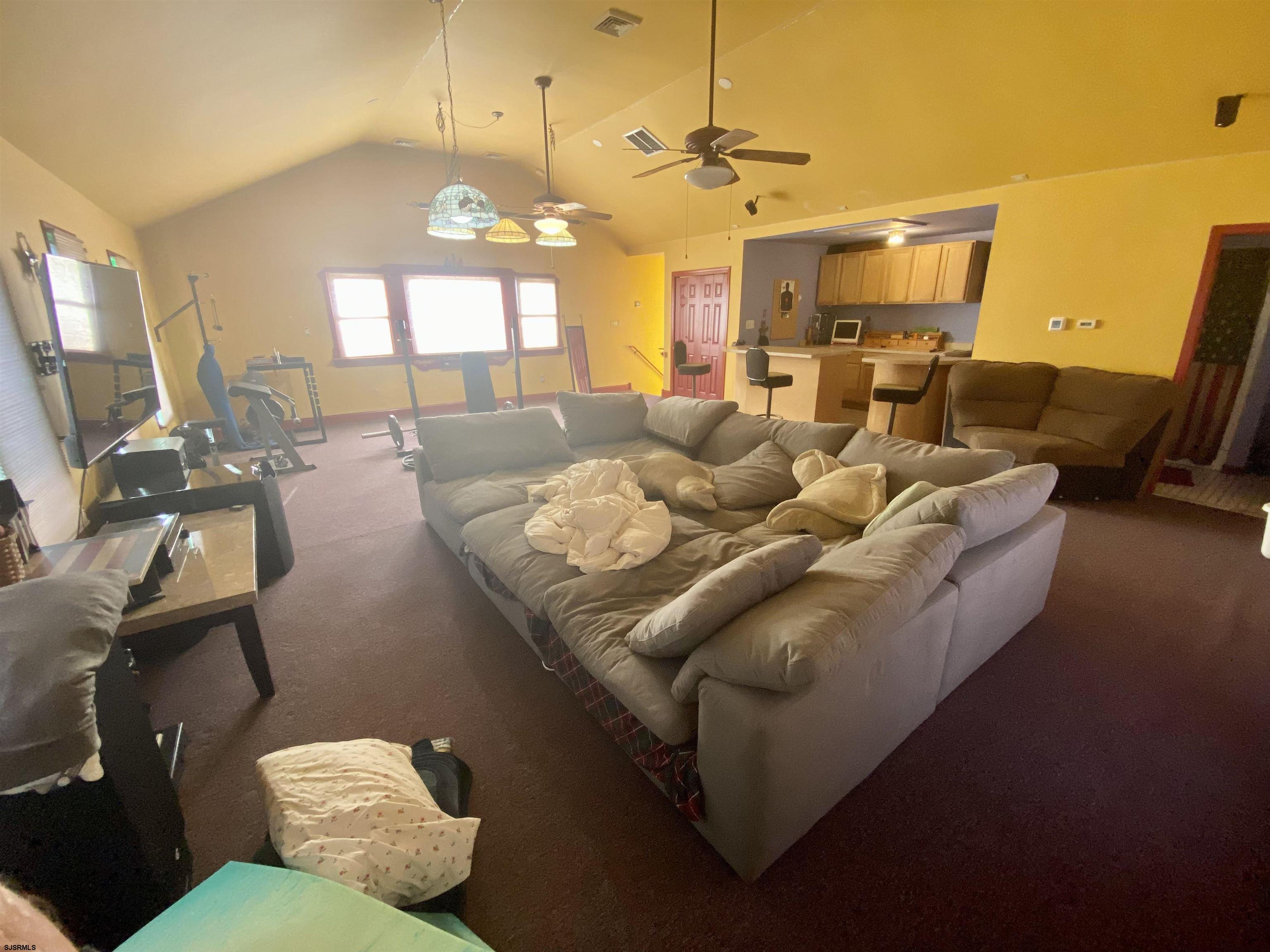6705 Weymouth Road Mays Landing, NJ 08330 - Photo 26 of 38 a living room with furniture and a chandelier