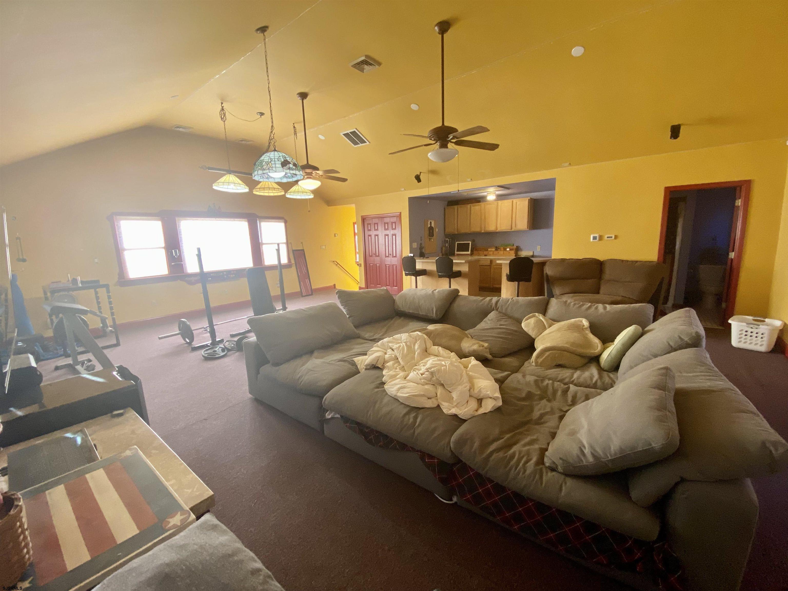 6705 Weymouth Road Mays Landing, NJ 08330 - Photo 28 of 38 a living room with furniture and a chandelier