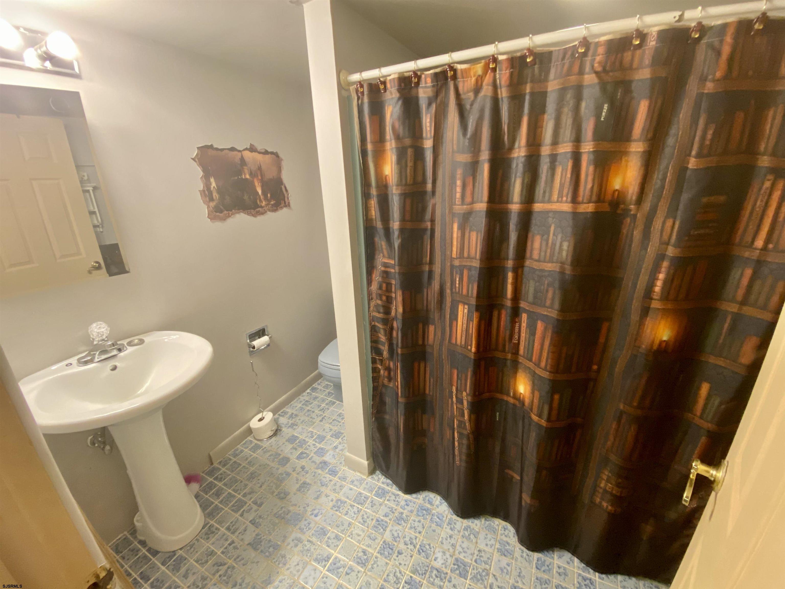 6705 Weymouth Road Mays Landing, NJ 08330 - Photo 38 of 38 a bathroom with a sink and a mirror