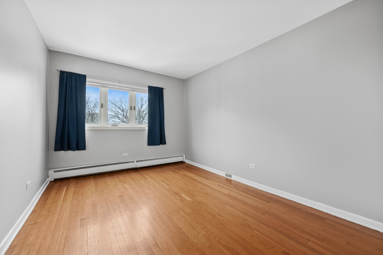 2033 Sherman Avenue, Unit 504 Evanston, IL 60201 - Photo 14 of 23 a view of an empty room with wooden floor and a window