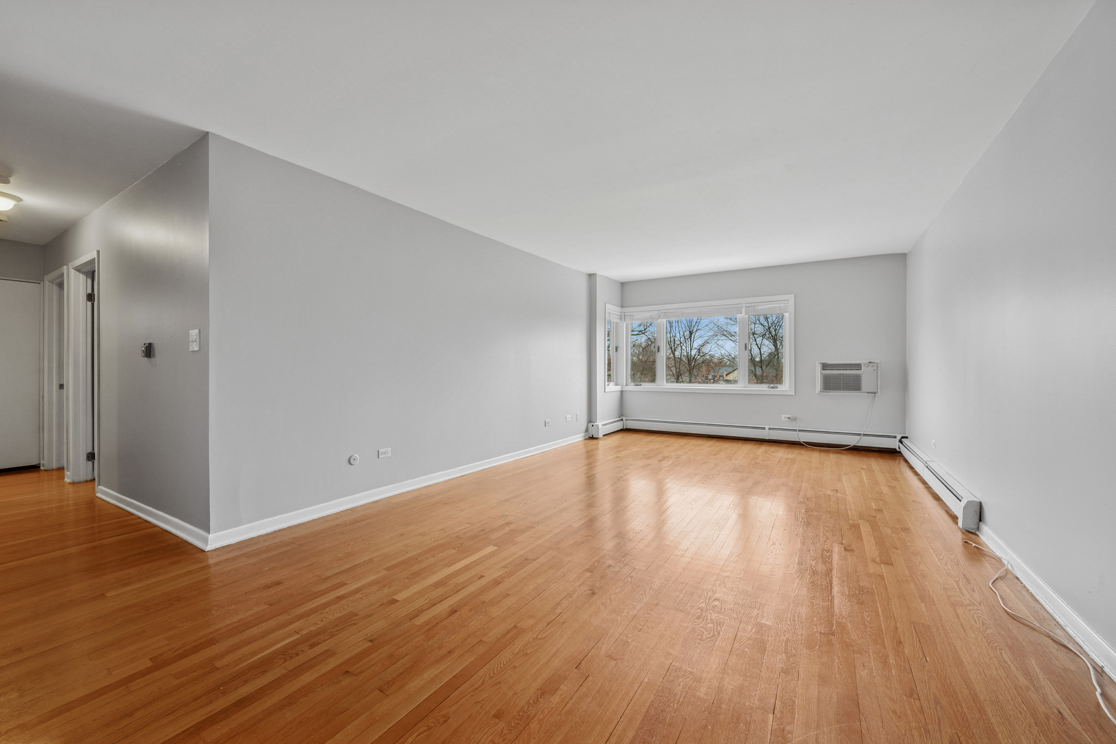 2033 Sherman Avenue, Unit 504 Evanston, IL 60201 - Photo 16 of 23 an empty room with wooden floor and windows