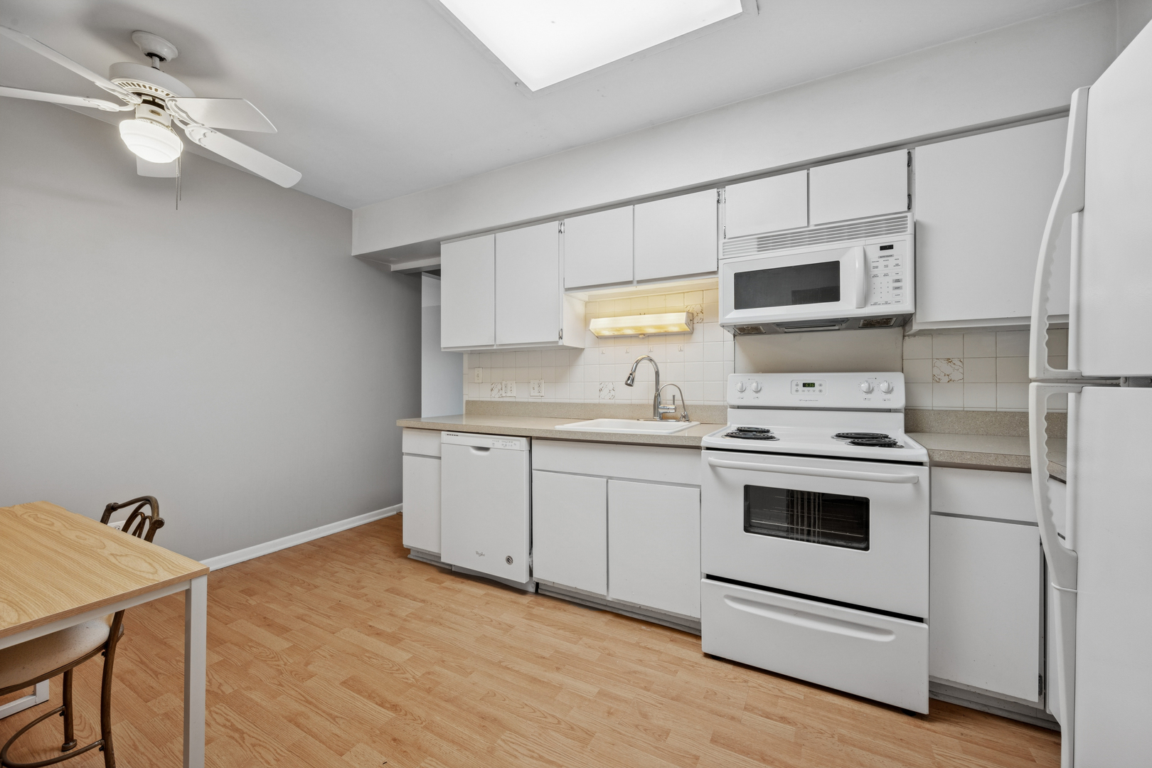 2033 Sherman Avenue, Unit 504 Evanston, IL 60201 - Photo 10 of 23 a kitchen with a stove a sink and a refrigerator