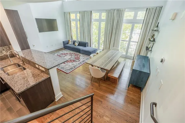 a living room with chairs and a flat screen tv