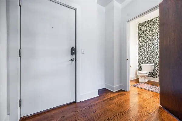 a big room with wooden floor and bedroom view