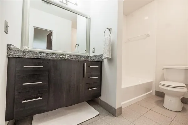 a bathroom with a toilet a sink and shower