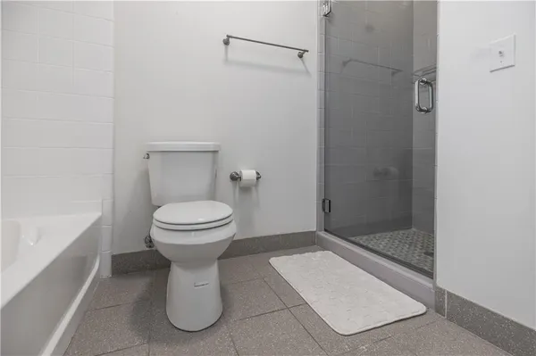 a bathroom with a toilet and a shower