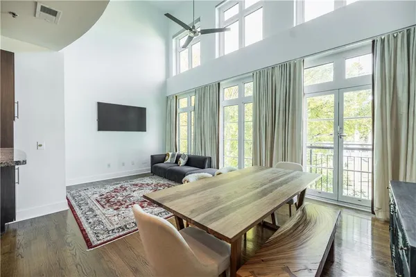 a living room with game table and a large window