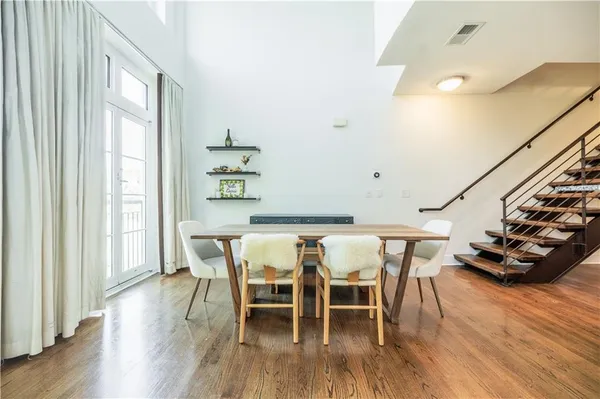 a dining room with furniture and wooden floor