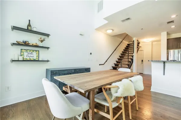 a view of a dining room with furniture and wooden floor