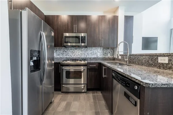 a kitchen with a sink stove and refrigerator