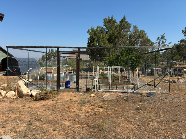 581 South 700 East Spring City, UT 84662 - Photo 28 of 42 Fenced garden area featuring raised beds, a greenhouse structures