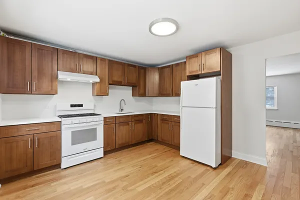 a kitchen with a refrigerator sink and cabinets