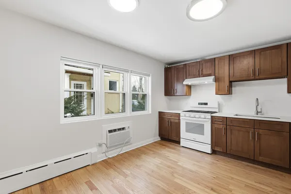 a kitchen with stainless steel appliances granite countertop a stove and a sink