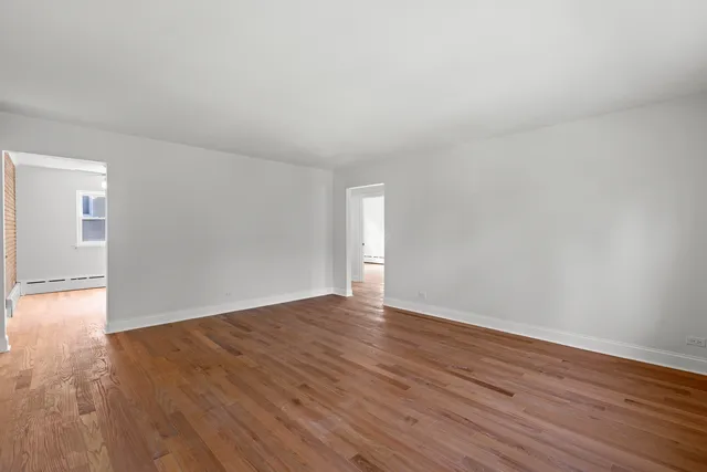 a view of an empty room and wooden floor