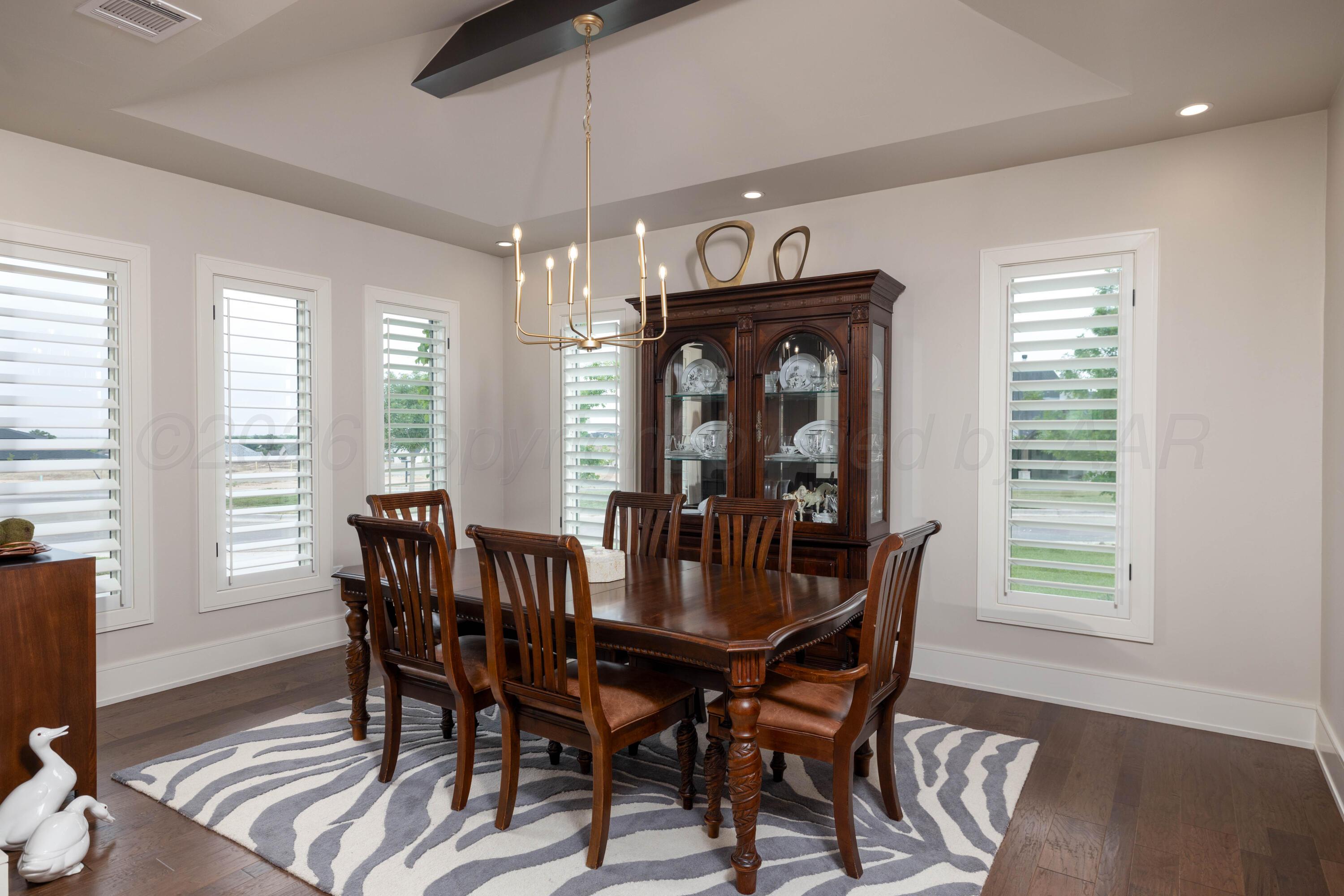 4508 South Rocking Chair Lane Amarillo, TX 79124 - Photo 12 of 48 a view of a dining room with furniture window and wooden floor