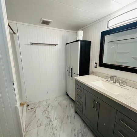 a bathroom with a double vanity sink and mirror