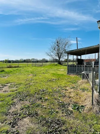 a view of a big yard with an outdoor space