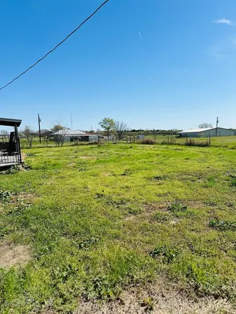 a view of a field with an ocean