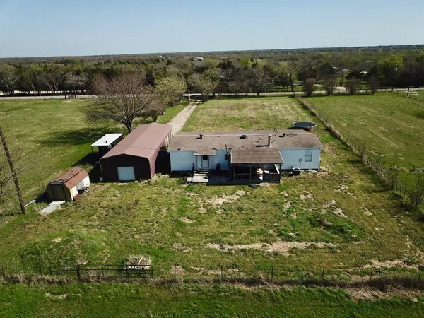 an aerial view of a house with a lake view