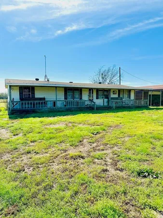 a view of a swimming pool with an outdoor seating and yard