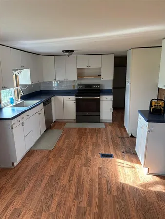 a large kitchen with a lot of counter space and stainless steel appliances