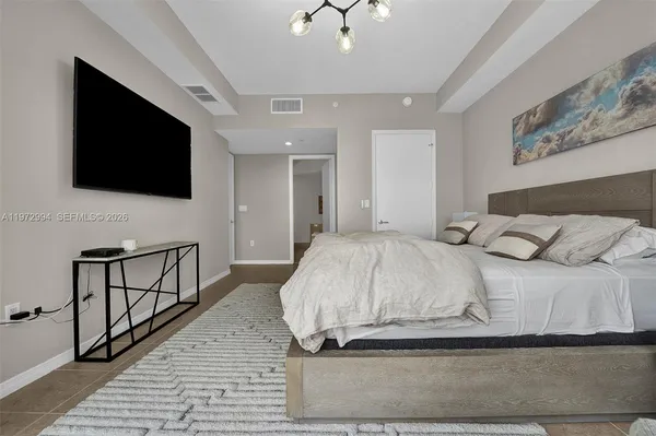 a bedroom with a bed and a flat screen tv