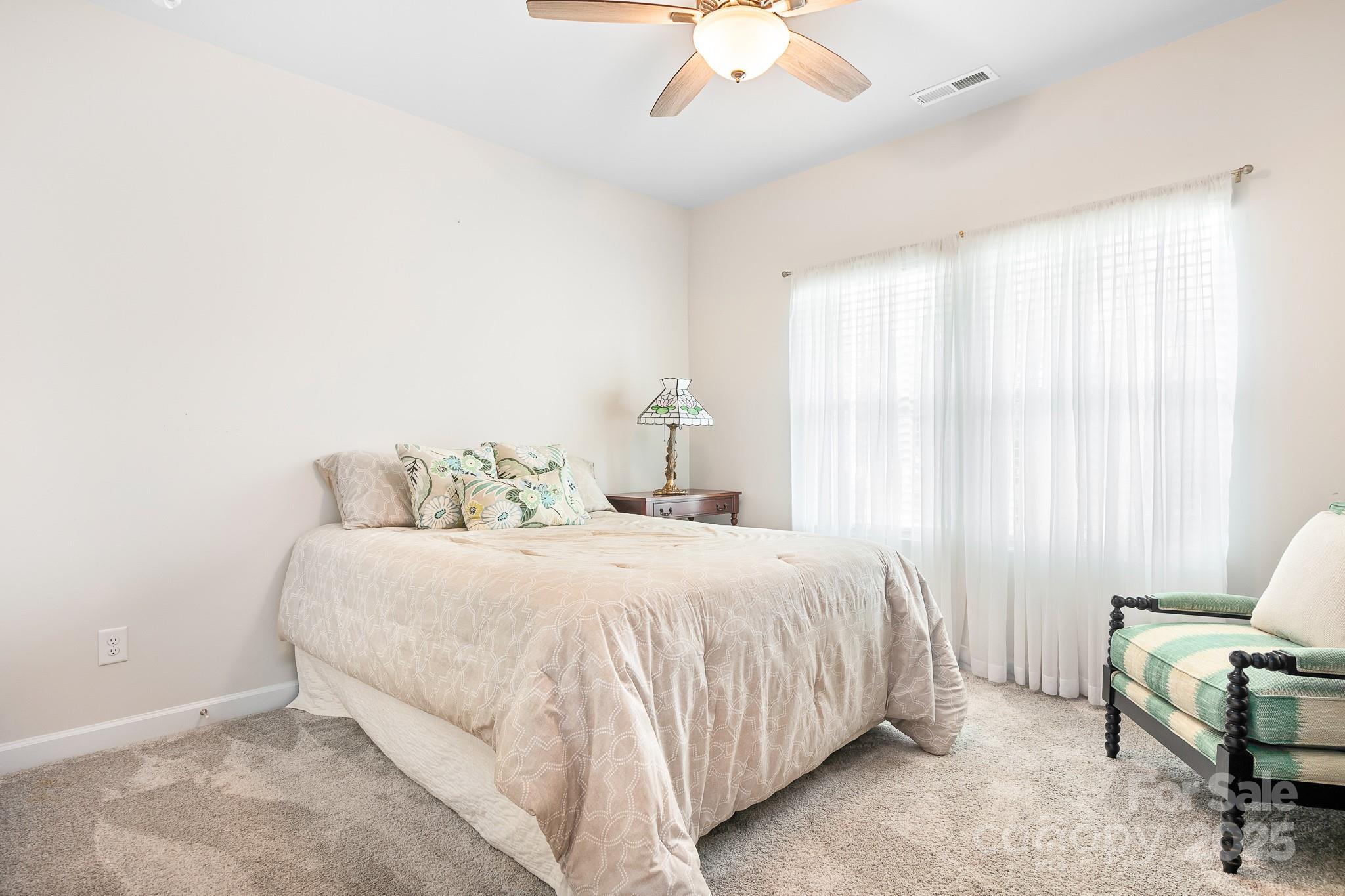 1885 Lotus Lane Denver, NC 28037 - Photo 21 of 43 a bedroom with a bed and a chandelier