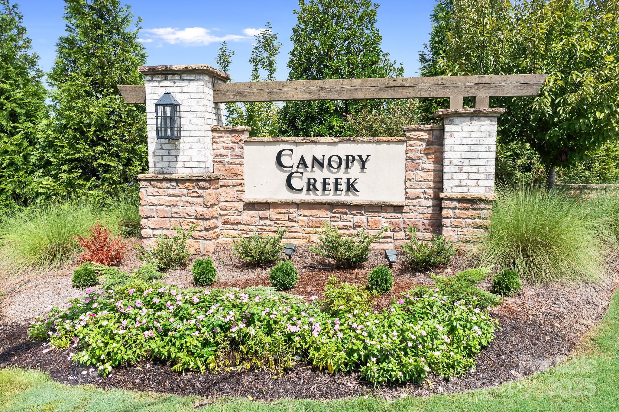 1885 Lotus Lane Denver, NC 28037 - Photo 29 of 43 a sign that is sitting on a wooden bench in a yard