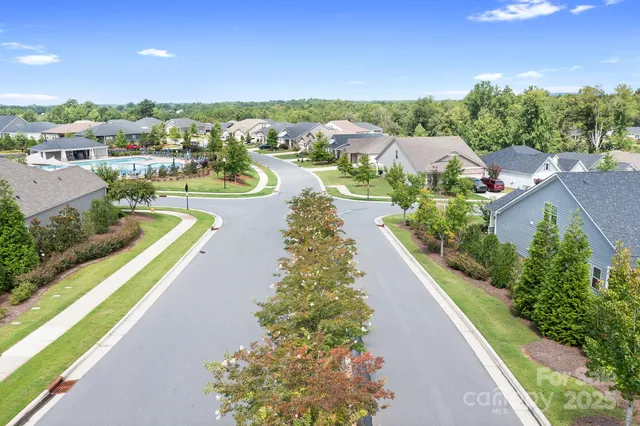 a patio with a table and chairs and potted plants