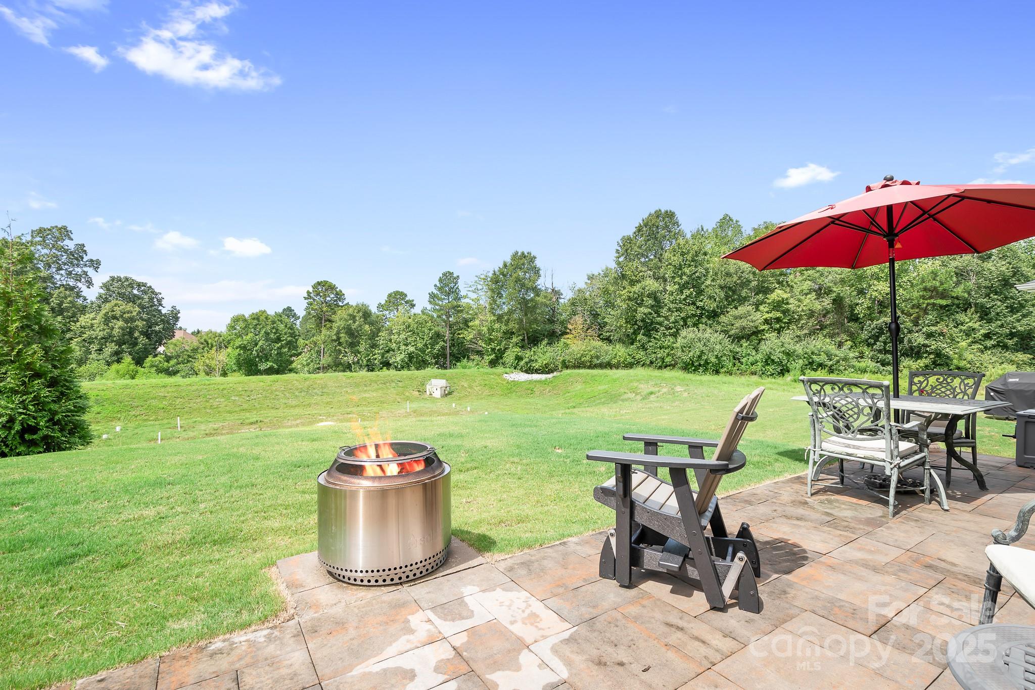 1885 Lotus Lane Denver, NC 28037 - Photo 3 of 43 a view of a patio with chairs and table under an umbrella
