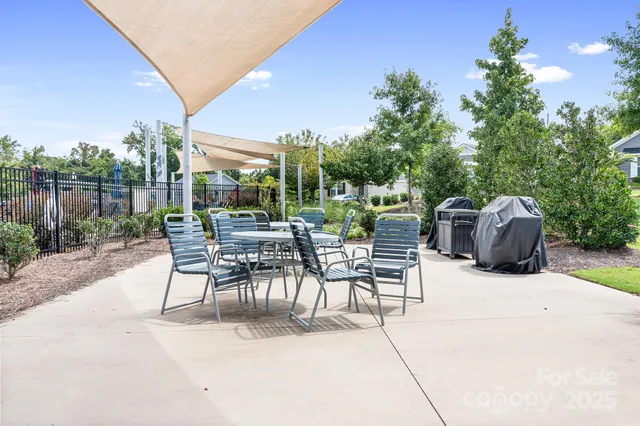 a view of a house with a yard and potted plants