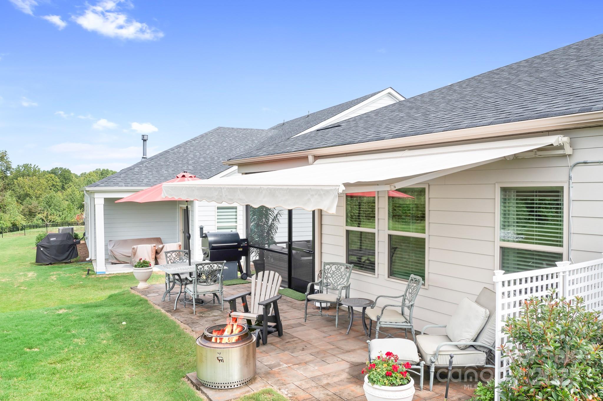 1885 Lotus Lane Denver, NC 28037 - Photo 4 of 43 a view of a patio with table and chairs potted plants and floor to ceiling window