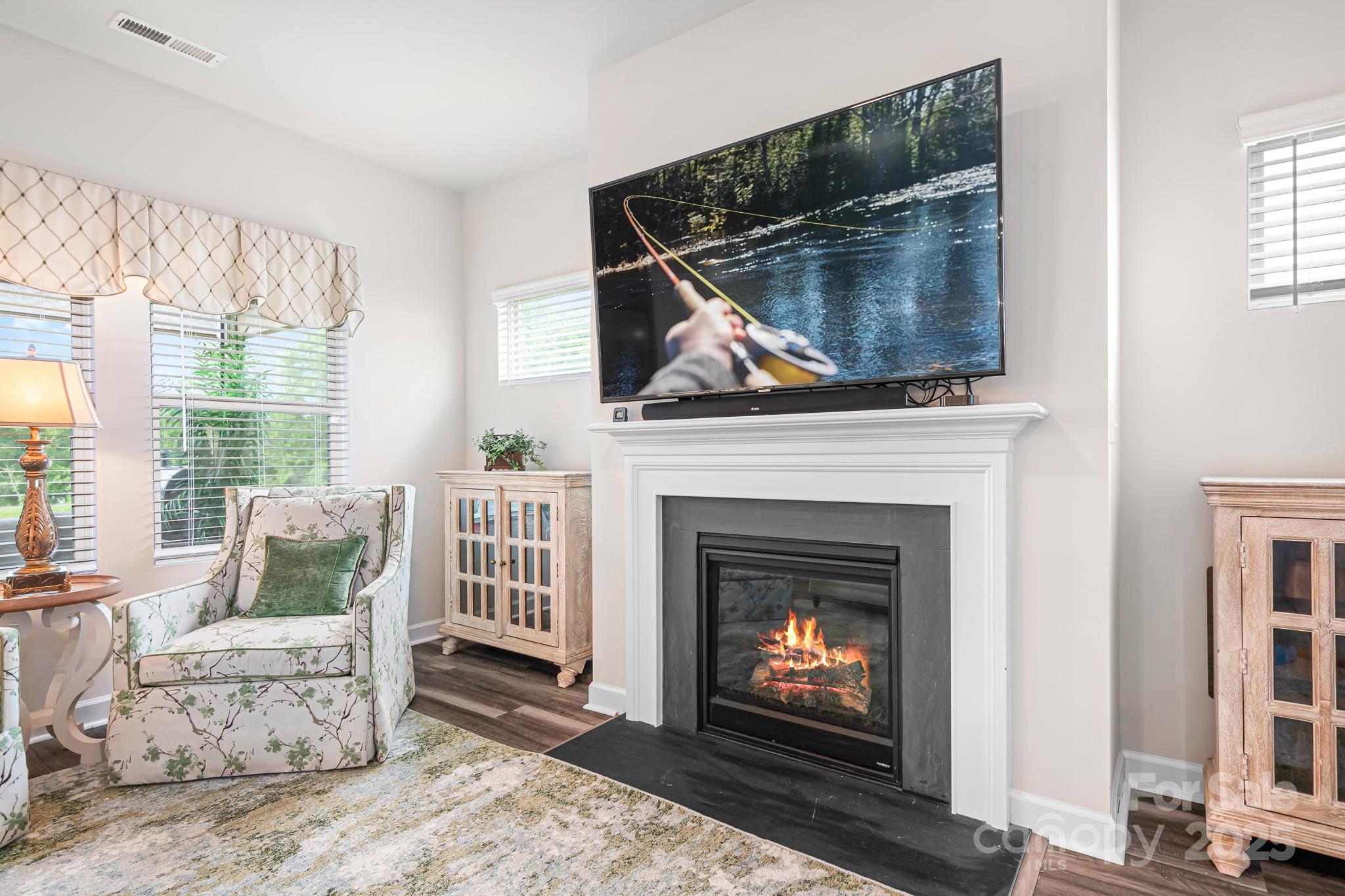 1885 Lotus Lane Denver, NC 28037 - Photo 8 of 43 a living room with furniture a flat screen tv and a fireplace