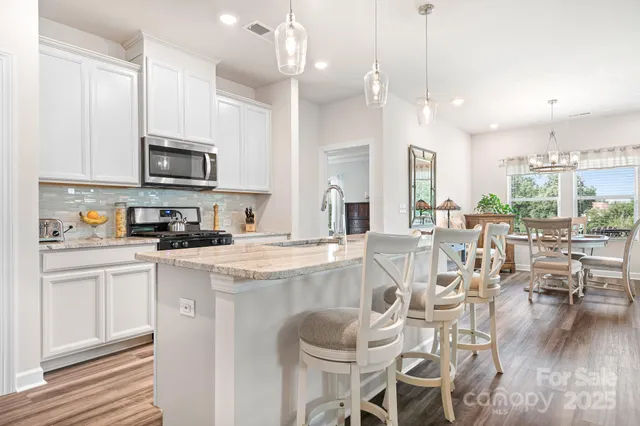 a kitchen with granite countertop stainless steel appliances and sink