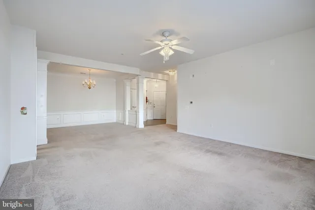 a view of an empty room with a ceiling fan