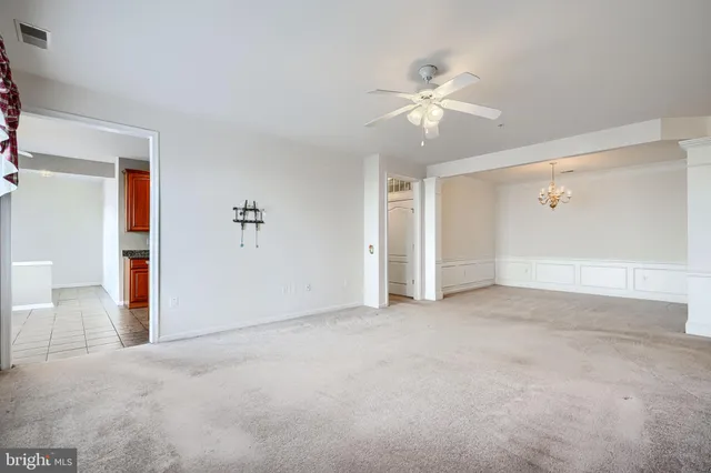 a view of an empty room with a ceiling fan