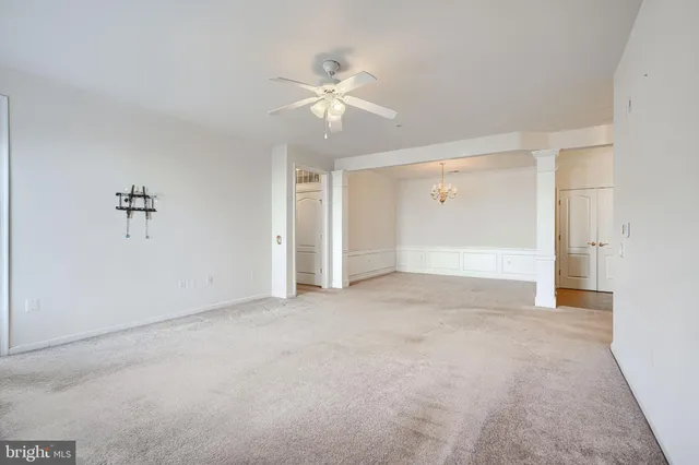 a view of an empty room with a ceiling fan