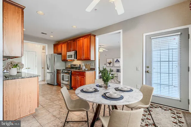 a large kitchen with stainless steel appliances granite countertop a stove a sink and a refrigerator