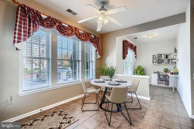 a dining room with furniture and window