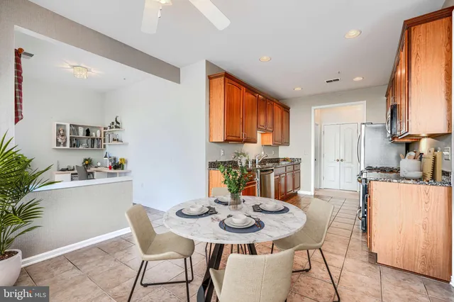 a view of an empty room with window and chandelier fan