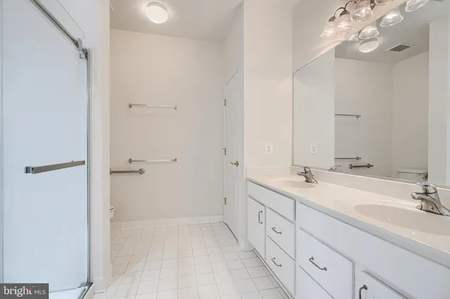 a spacious bathroom with a granite countertop sink a mirror and a