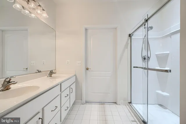 a spacious bathroom with a granite countertop sink a toilet and shower