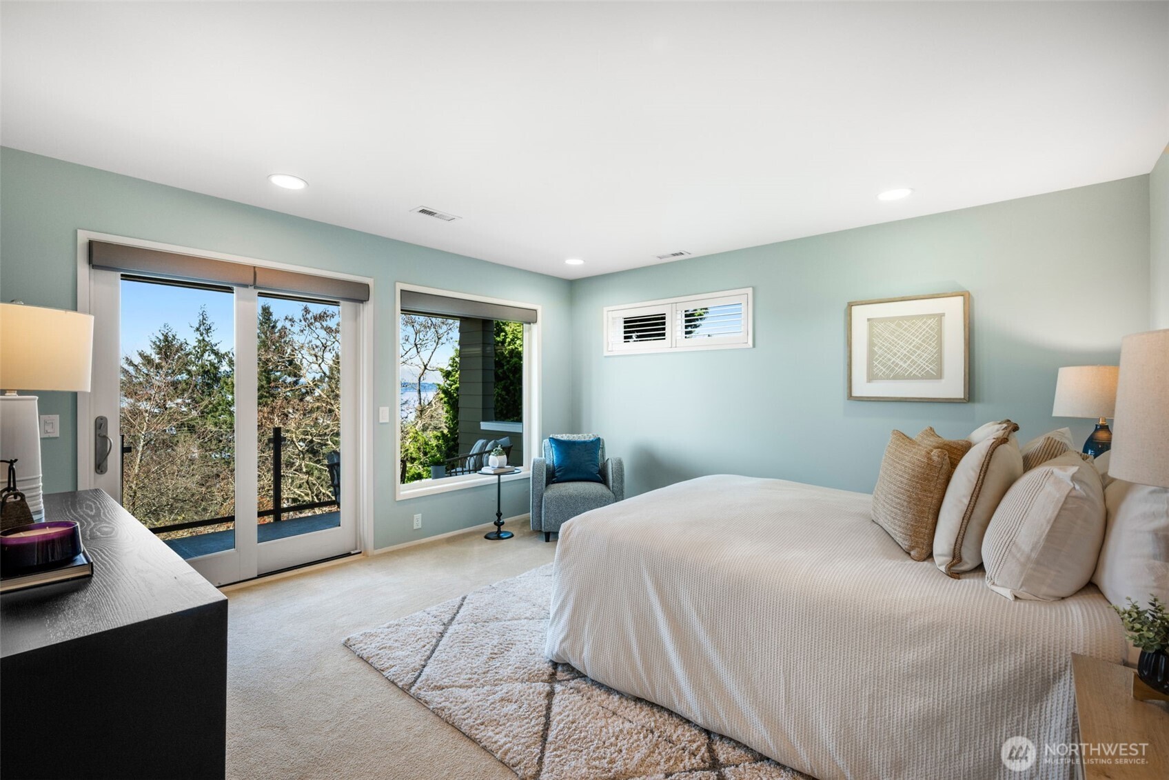 4017 56th Avenue Southwest Seattle, WA 98116 - Photo 14 of 39 a bedroom with a large bed and a large window