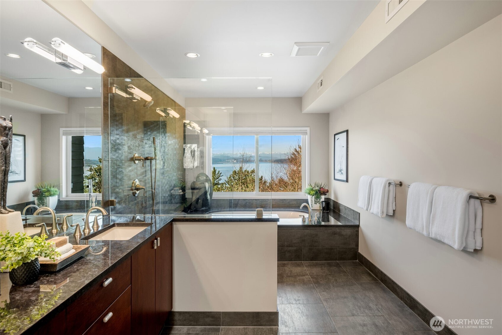 4017 56th Avenue Southwest Seattle, WA 98116 - Photo 16 of 39 a large living room with stainless steel appliances kitchen island granite countertop furniture and a large window