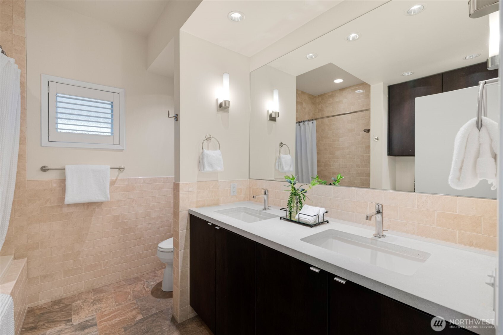 4017 56th Avenue Southwest Seattle, WA 98116 - Photo 25 of 39 a bathroom with a sink double vanity and a mirror