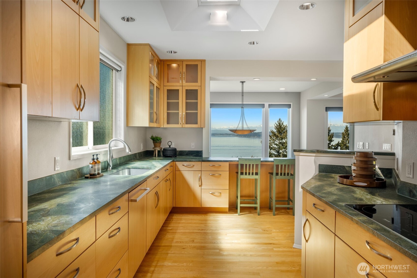 4017 56th Avenue Southwest Seattle, WA 98116 - Photo 9 of 39 a large kitchen with stainless steel appliances granite countertop a sink and a counter space