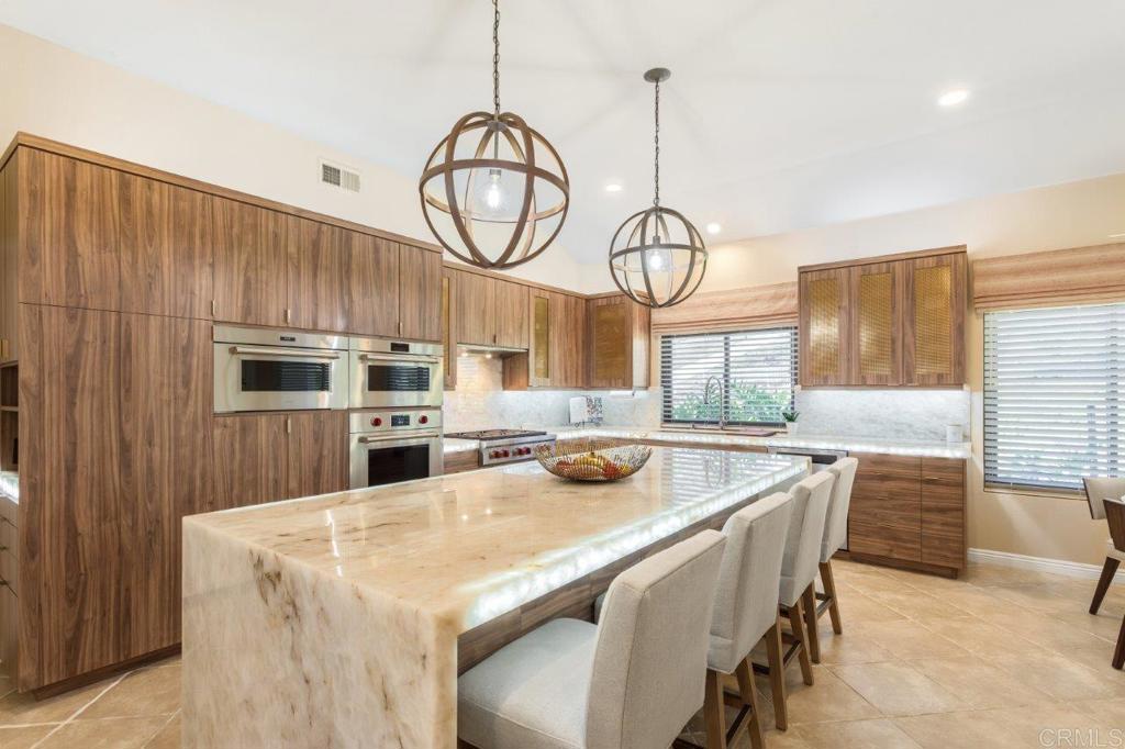 9369 Quail Canyon Road El Cajon, CA 92021 - Photo 11 of 43 a kitchen with furniture a window and stainless steel appliances