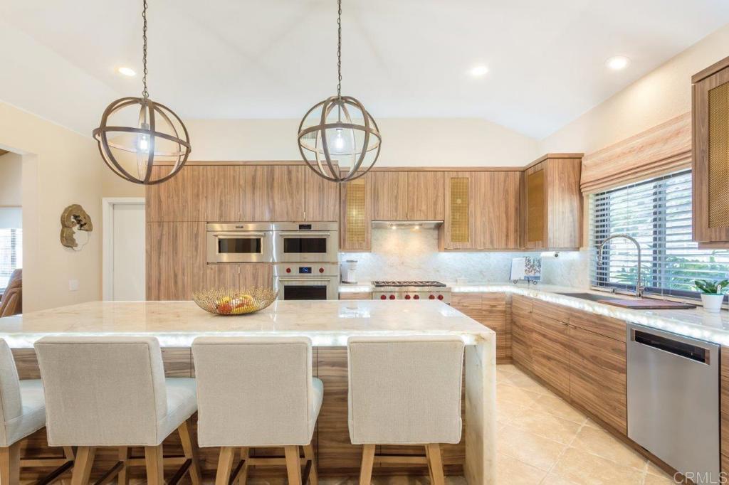 9369 Quail Canyon Road El Cajon, CA 92021 - Photo 14 of 43 a kitchen with furniture a window and stainless steel appliances